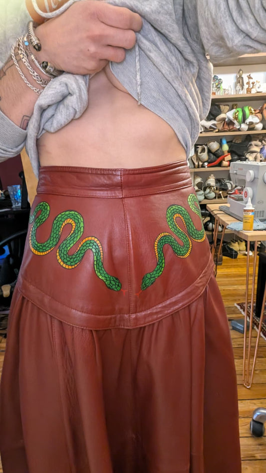 Hand-painted red leather skirt with snake tattoo artwork